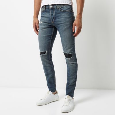 Faded blue wash ripped Sid skinny jeans